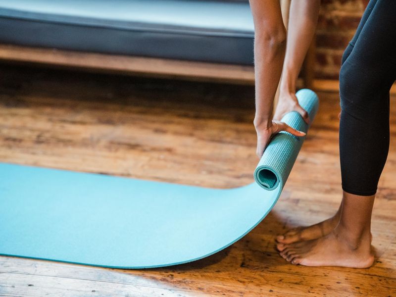Detailed close-up of a yoga mat on a floor with blue light